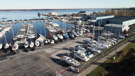 Flying-forward-over-a-local-Marina,-various-boats-being-Winterized-for-the-season