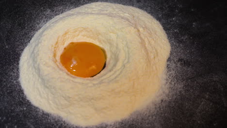 Egg-yolk-falling-into-flour-in-slowmotion