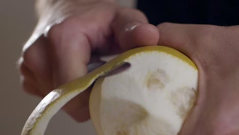 Slow-Motion-Shot-Of-Gentle-Hands-Peeling-Lemon-Fruit-Carefully