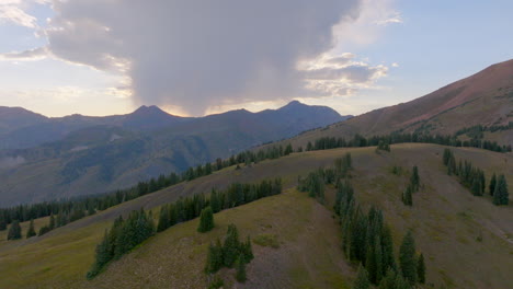 Aerial-of-mountain-range-with-push-over-ridge-line-towards-sunset-in-the-Colorado-Rockies