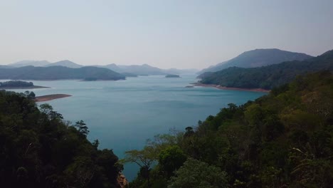Aerial-drone-view-of-mountains,-lake-and-forest-in-Kerala,-Idukki
