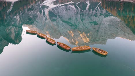 Dramatic-Aerial-View-Row-Boats,-Lake-Braies,-Italy