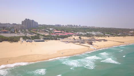 Sunny-Summer-Aerial-in-Israel,-Ashkelon-Beach---Flyby-from-beach-to-the-city