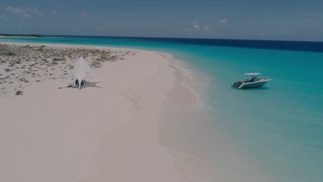 Glamping-Exotic-Beach-In-Caribbean-Island-VIP-speedboat,-Aerial-shot-Cayo-de-Agua-Los-Roques