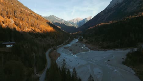Scenic-idyllic-sunset-mountain-valley-river-canyon-with-fresh-blue-water-in-the-Bavaria-Austria-alps,-flowing-down-a-beautiful-forest-along-trees-near-Sylvenstein-Speicher-and-Walchensee