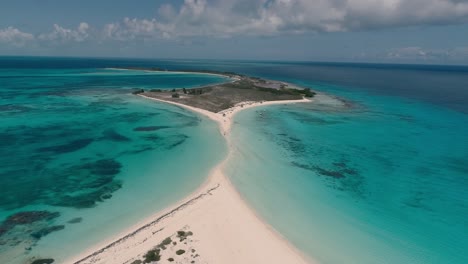 Aerial-landscape-sandbar-surrounded-by-coral-reef,-dolly-in-descent-cayo-de-agua-island-Los-Roques