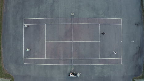 4K-Drohne-Mit-Draufsicht-Von-Menschen,-Die-Auf-Einem-Tennisplatz-Im-Freien-Tennis-Spielen