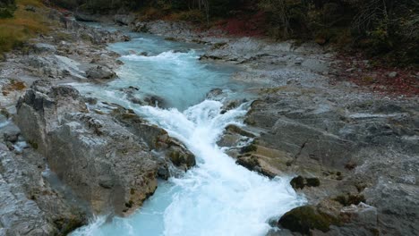 Mountain-river-waterfall-canyon-with-fresh-blue-water-in-Bavaria-Austria-alps,-slow-motion-flowing-along-a-forest-and-trees-near-Sylvenstein-Speicher-and-Walchensee