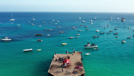 Flying-over-the-pier-in-Santa-Maria,-Sal-Island---Cape-Verde