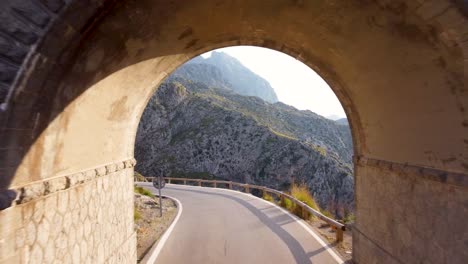 Drone-flying-through-tunnel-in-Tramuntana-mountains,-Mallorca