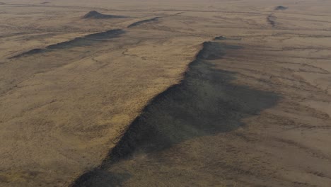 Mountain-Ridges-in-Dry,-Namibia-Desert---Aerial-Drone-Flight-of-Africa-Landscape