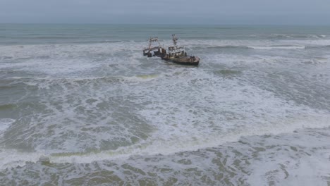 Anciet-Ruins-of-Shipwrecked-Boat-on-Namibia's-Skeleton-Coast,-Aerial