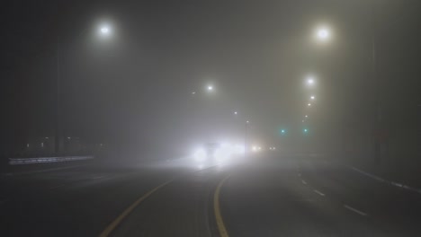 Cars-Drive-On-The-Highway-On-A-Foggy-Night