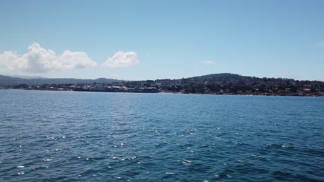 Gimbal-wide-panning-shot-approaching-Monterey,-California-from-a-boat-on-the-ocean