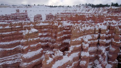 Aerial-4K-footage-of-Bryce-Canyon-National-Park-covered-in-snow-in-Utah,-USA
