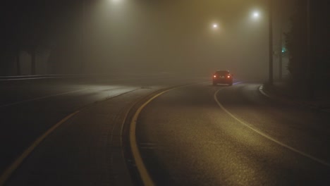 Rear-View-Of-Car-In-Motion-On-Country-Road-On-Foggy-Night---wide