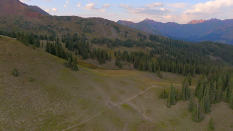Aerial-flyover-hiking-trail-and-trees-on-a-ridge-in-the-Colorado-Rockies-on-a-beautiful-summer-day