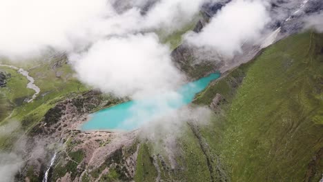 Side-drone-shot-of-turquoise-Lake-Humantay-in-the-mountains-of-Cuzco