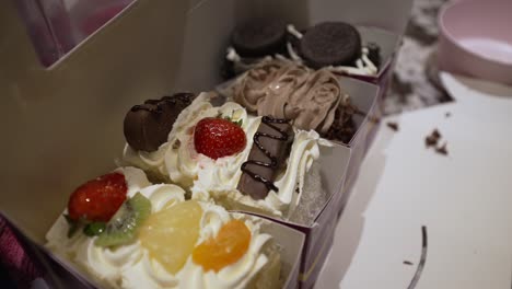 Close-Up-View-Of-Tasty-Fresh-Cake-Slices-Topped-With-Fresh-Fruit-And-Chocolate
