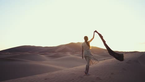 Woman-is-walking-bare-feet-in-the-desert-in-a-fashion-dress,-artsy-and-cinematic-footage
