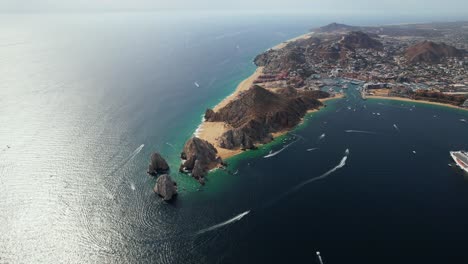 Aerial-overview-of-the-cape-at-Cabo-San-Lucas,-Mexico---rising,-pull-back,-drone-shot