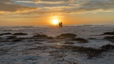 Timelapse-of-couple-on-the-beach-watching-the-sunset-at-St