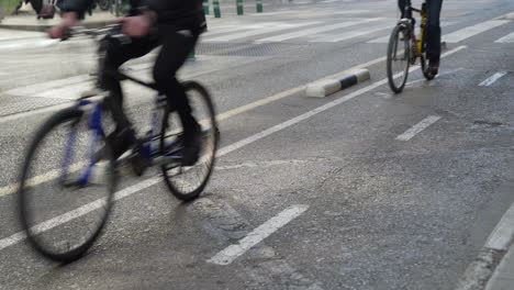 Bike-lane-with-cyclists-circulating-in-the-center-of-the-city-of-Valencia,-Spain