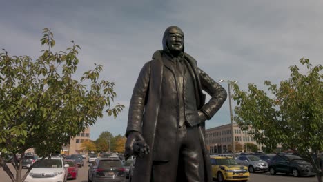 Statue-of-auto-pioneer-Louis-Chevrolet-in-Flint,-Michigan-with-gimbal-video-moving-forward