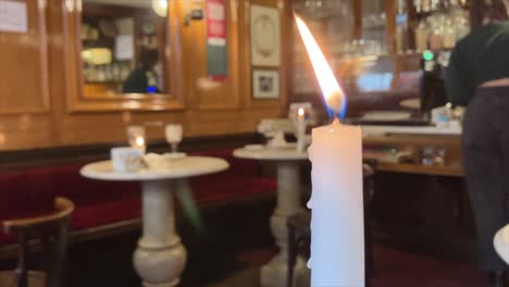 Candle-burning-on-the-table-of-historical-Caffè-Al-Bicerin-in-Turin
