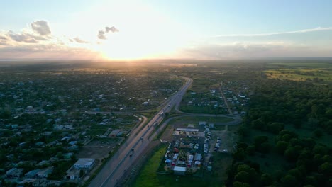 Aerial-circling-drone-panoramic-scene-of-cars-driving-on-dual-carriageway-Autovia-del-Este-at-sunset