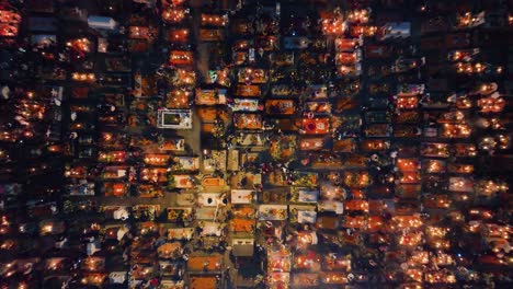 Aerial-view-above-a-illuminated-and-decorated-cemetery,-during-Dia-de-Muertos,-in-Mexico-city---cenital,-drone-shot