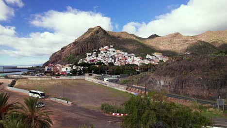 Aerial-of-tropical-town-with-colorful-house-on-a-Tenerife-beach,-sunny
