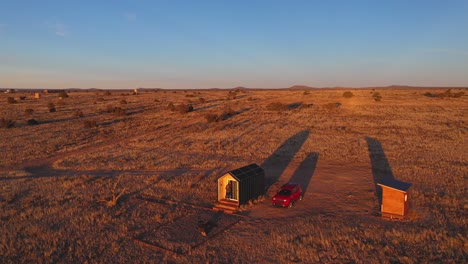 Tiny-home-aerial-shot-during-golden-hour-in-Arizona-desert-landscape