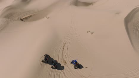 Fly-Over-Dune-Buggy-Riders-on-ATV's-in-Desert-Dunes-on-Sunny-California-Day,-Glamis-Weekend