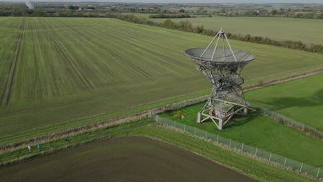 Aerial-orbit-over-the-radiotelescope-antenna-at-the-Mullard-Radio-Astronomy-Observatory-in-Cambridge,-UK