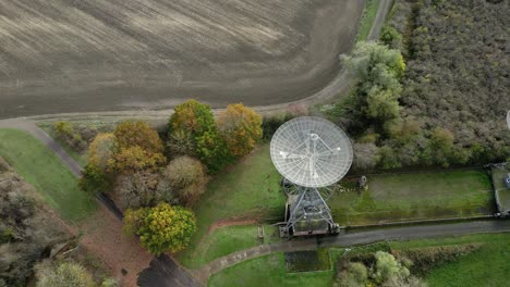 Aerial-view-flying-across-Mullard-MRAO-radio-observatory-dishes-on-Cambridge-farmland