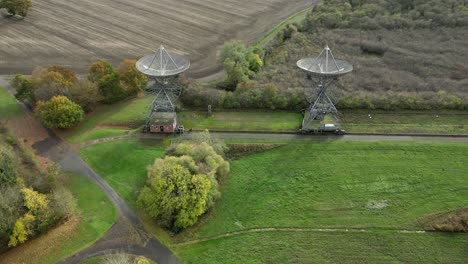 Aerial-shot-of-the-antenna-array-at-the-Mullard-Radio-Astronomy-Observatory---a-one-mile-radio-telescope---backward-fly