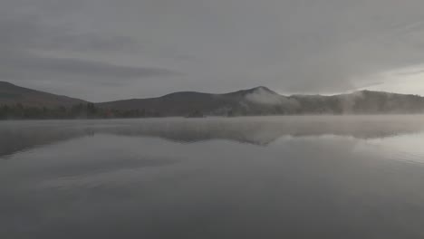 Aerial-shot-flying-low-towards-Borestone-Mountain-Lake-Onawa-morning-fog