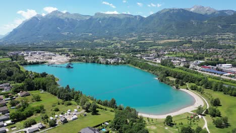 Light-Blue-Turquoise-Grignon-Lake-and-sandy-Beach-in-French-Alps---Aerial