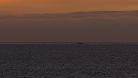 Boat-Drone-Follow-At-Sunset-On-An-ocean
