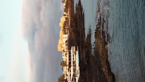 Vertical-drone-shot-Lanzarote-beach-with-house-on-shore