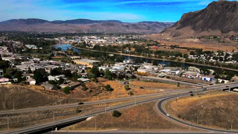 Approach-hyperlapse-shot-of-Vehicles-driving-on-the-Highway-1-and-Yellowhead-Intersection-in-Kamloops,-Thompson-Okanagan-in-British-Columbia-with-Mount-Paul-In-the-Background