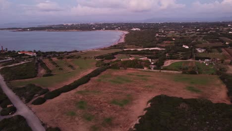 Aerial-drone-view-of-Sardinian-beach-and-countryside-in-Calasetta,-forward,-dusk