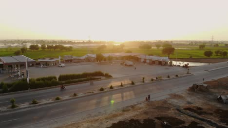 An-aerial-view-of-traffic-on-the-National-Highway-of-Pakistan,-in-the-desert-of-Sindh
