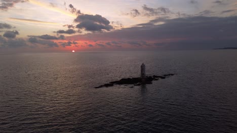 Incredible-view-of-stunning-sunset-with-offshore-Lighthouse-in-Calasetta,-aerial