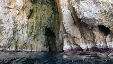 Boat-point-of-view-of-Vedusella-or-Verdusella-caves-on-Adriatic-side-of-Mediterranean-sea,-Italy