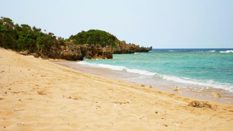 Empty-gold-sand-beach-with-turquoise-water,-Okinawa,-slow-motion