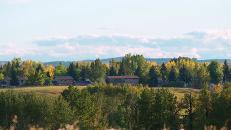Long-shot-of-homes-in-a-rural-location-in-the-late-summer-on-a-clear-evening-in-Calgary,-Alberta,-Canada