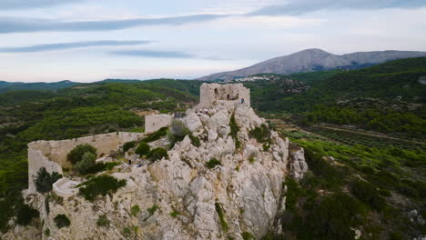 Aerial-arc-shot-of-medieval-Kastellos-castle-on-hilltop,-Kritinia,-Rhodes