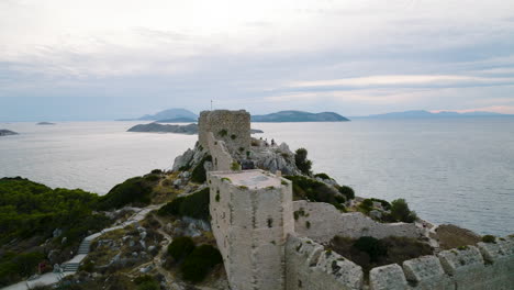 Half-aerial-orbit-around-Castle-of-Kritinia-overlooking-Aegean-Sea,-Rhodes